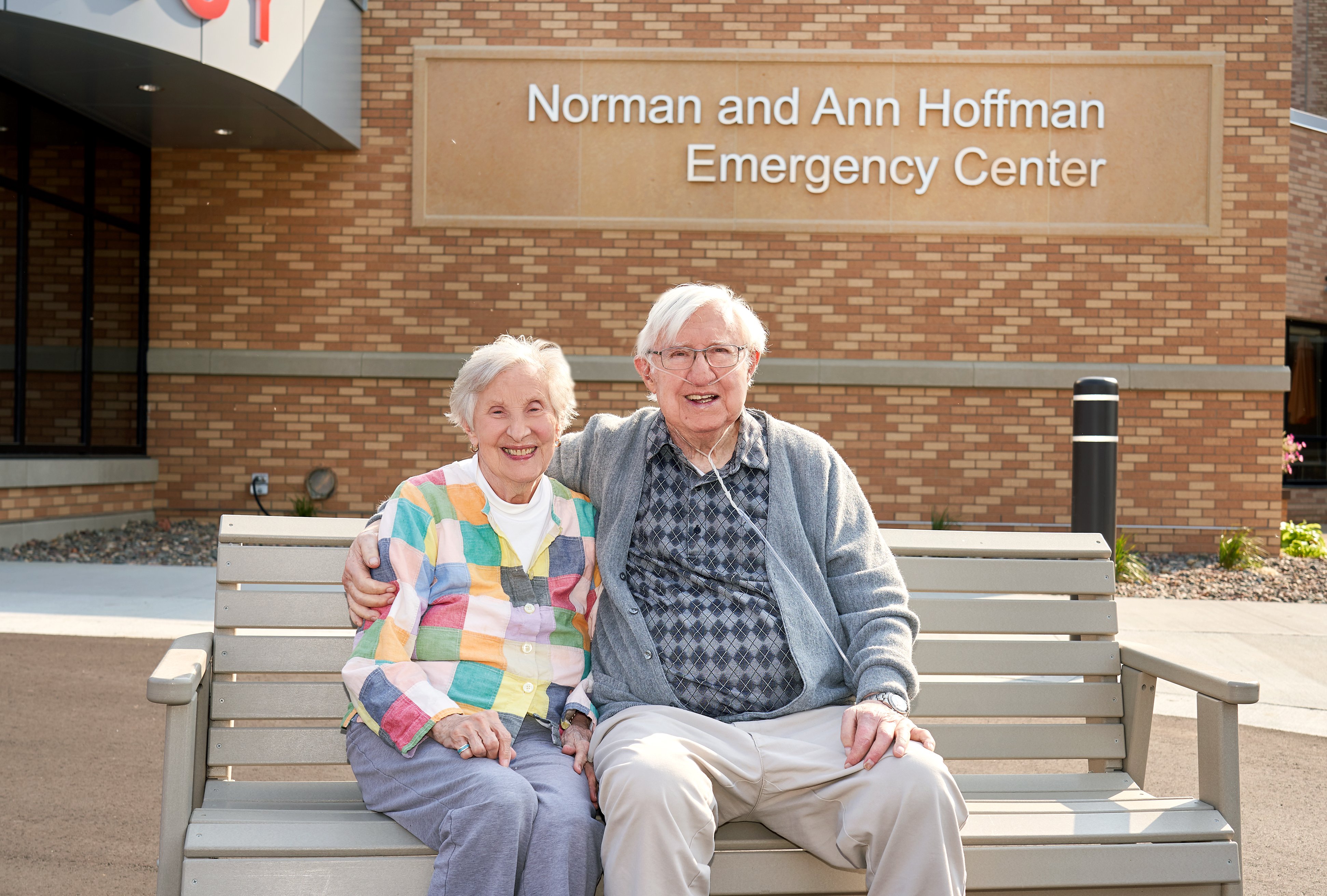 Photo of Norman and Ann Hoffman in front of the Waconia campus emergency department named in their honor